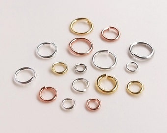 May include: Assortment of jump rings in silver, gold, and rose gold finishes. The jump rings are various sizes.