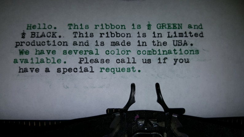 May include: Typewriter with a sheet of paper that reads "Hello. This ribbon is GREEN and BLACK. This ribbon is in Limited production and is made in the USA. We have several color combinations available. Please call us if you have a special request."