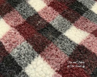 May include: Close-up of a soft, fuzzy fabric with a plaid pattern in shades of burgundy, white, and gray. The fabric has a fluffy texture and is perfect for crafting projects or home decor.
