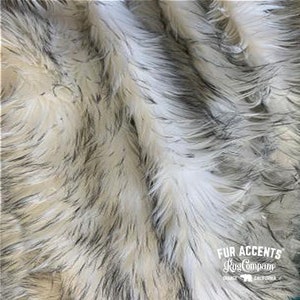 May include: White and black faux fur fabric with a long pile. The fabric is soft and fluffy, and it has a natural look. The fabric is made by Fur Accents Rug Company, Orange, California.
