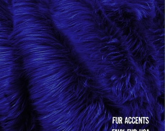 May include: Close-up of a deep blue faux fur fabric. The fabric has a soft, fluffy texture. The text "FUR ACCENTS FAUX FUR USA" is visible in the bottom right corner of the image.