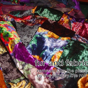 May include: A patchwork of colorful velvet fabric scraps in various shades of red, green, purple, and blue. The fabric is arranged in a random pattern and has a luxurious, textured feel. The text "fur and fabric remnants by the piece by the yard by the roll" is printed on the fabric.