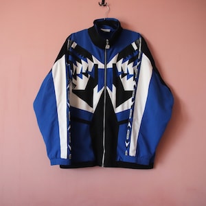 May include: A blue, black and white patterned jacket with a zip closure.