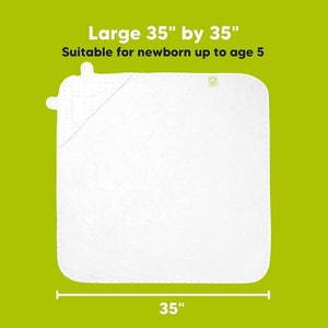 May include: White hooded baby towel, 35 inches by 35 inches, suitable for newborns up to age 5. The towel has a hood with a dotted pattern and a small logo. The background is a solid green color.