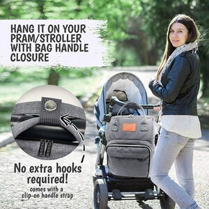 May include: A gray diaper bag with a clip-on handle strap that can be attached to a stroller. The bag has a zipper closure and a small pocket on the front. The text "HANG IT ON YOUR PRAM/STROLLER WITH BAG HANDLE CLOSURE" is displayed in a white box above the image. The text "No extra hooks required! comes with a clip-on handle strap" is displayed below the image.