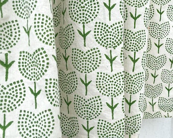 May include: A white fabric curtain featuring a repeating pattern of green flowers. Each flower is composed of small, individual green dots forming a rounded, tulip-like shape with a simple green stem and two small leaves extending from the base.