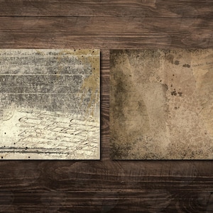 May include: Two vintage-style scrapbook paper sheets with a distressed look. One sheet features a weathered, layered design with script and splatters. The other sheet has a plain, aged appearance with stains and a map-like design.