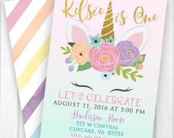 May include: A pastel-colored birthday invitation featuring a unicorn design. The invitation includes the text "Kelsie is One" in gold glitter, along with event details such as the date, time, and location. The envelope has a striped pattern.