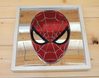 May include: A framed mirror with a red and black Spider-Man mask design.