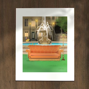 May include: An art print depicting an orange sofa in front of a fountain. The artwork shows a scene with a fountain, buildings, and a lamp. The sofa has a fringed base and is on a green lawn. The print is on a white background.