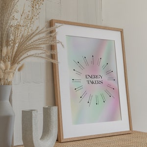 May include: A framed print with a rainbow gradient background and black text that reads "ENERGY TAKERS" in a circle with arrows pointing to words like "alcohol", "overthinking", "dehydration", "excess screen time", "people pleasing", "overworking", "inconsistent sleep", "stress", "judgement", "junk food", "worry", "secondary lifestyle", "social media".