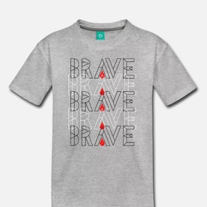 May include: A gray t-shirt with the word "BRAVE" repeated four times in black outlined text with a red blood drop in the center of each word.