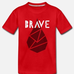 May include: Red kids' t-shirt with a white geometric design and the word "BRAVE" in white letters.