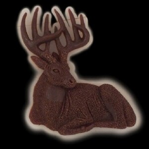 May include: A brown, ceramic sculpture of a deer lying down with large antlers. The deer has a detailed, textured surface.