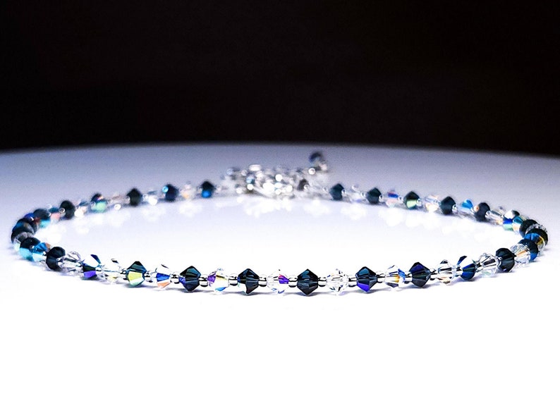 iridecent rainbow ab blue and clear interspersed bicone crystal necklace against a white background