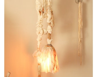 Artisanal Hanging Light Lamp, vintage, rustic wall light with cord. Wall lighting floating on a natural tree branch. Slow making, eco dyed