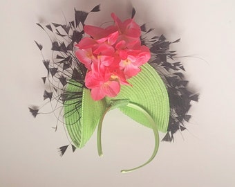 Green Kentucky Derby Fascinator with Pink Floral and Black Feather Accent Detail.