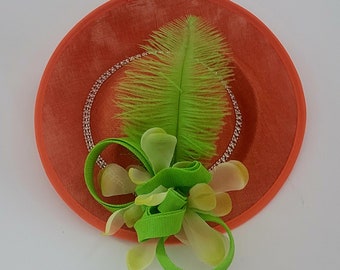 Orange Fascinator with Crystal Chain and Green Feather Detail.