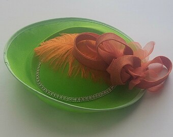 Green Fascinator with Crystal Chain and Orange Feather Detail.