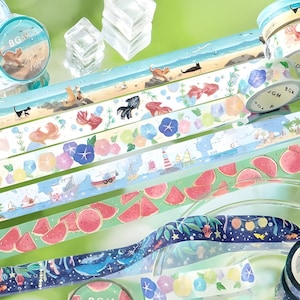 Achtergrondmuziek. Washi-tape. Summer Limited 2025. Watermeloen. Strand. Katten. Goudvis. Walvis. Lantaarns. Vuurtoren.