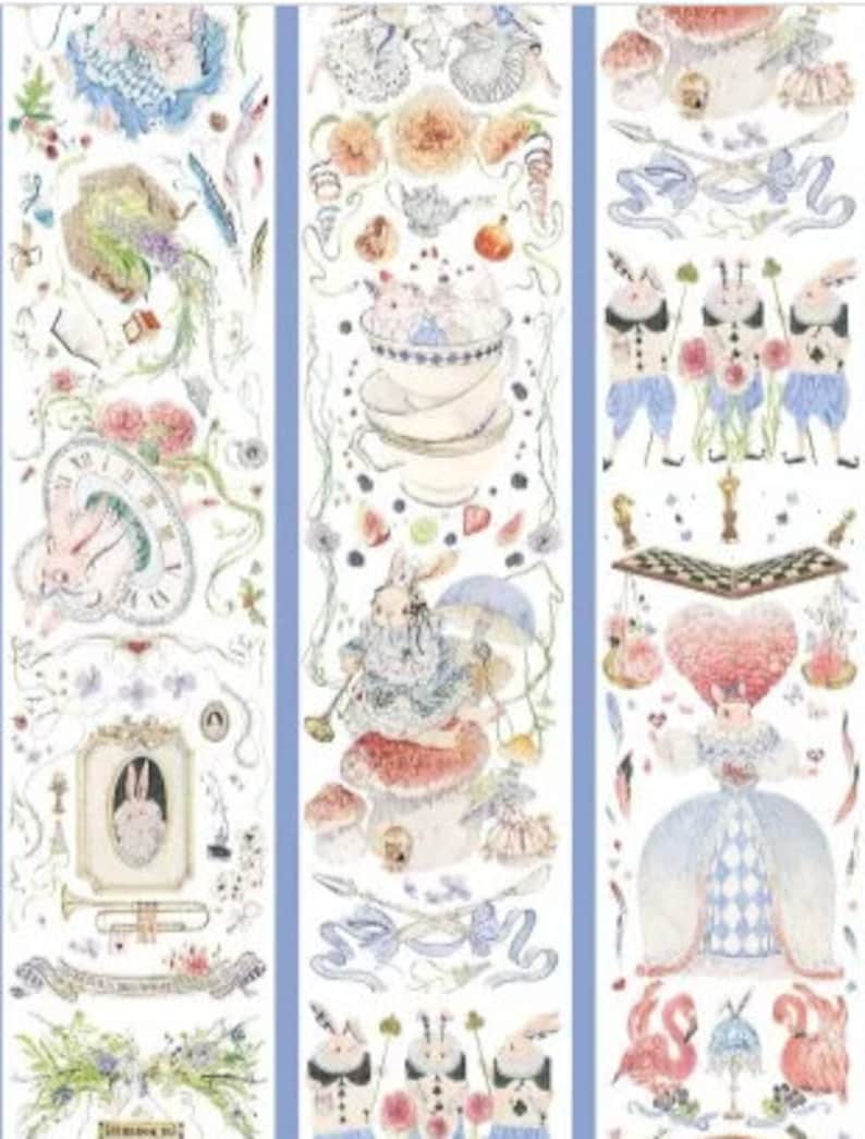 May include: Three rolls of decorative washi tape with a whimsical Alice in Wonderland theme. The tape features illustrations of rabbits, teacups, flowers, playing cards, and other whimsical elements in a watercolor style. The tape is white with a light blue border.