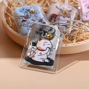 Adorable cat omamori. Japanese amulet. Shinto. Buddhist. Maneki neko. Lucky cat. Shiba inu. Sakura. Cherry blossom. Carp. Koi fish.
