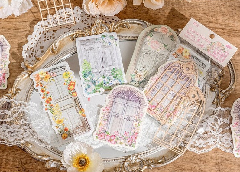 May include: A set of decorative stickers featuring vintage-style doors and windows with floral accents. The stickers are printed on white paper and have a delicate, romantic aesthetic. The text on the sticker reads "Flower Garden Series - Many Joint Stickers".