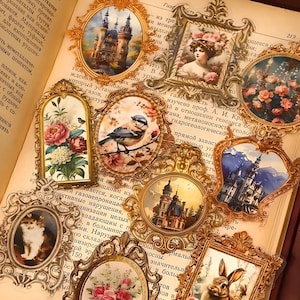 May include: A collection of vintage-style stickers featuring ornate gold frames with various images, including castles, flowers, birds, and a rabbit. The stickers are on a book page with text in Russian.