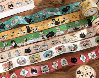May include: Decorative washi tape rolls with cat and dessert illustrations. The tape features various designs, including black cats, cakes, coffee cups, and other treats. The rolls are in shades of teal, yellow, brown, white, and red.