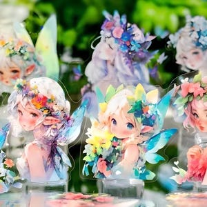 May include: A set of eight colourful fairy figurines with floral crowns and wings. The figurines are made of clear acrylic and have a painted design.