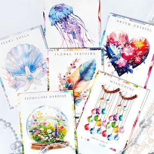 May include: Six watercolor illustrations on white cards with different themes. The cards feature a pearl shell, floral feathers, a dream crystal, a snow globe, a wind chime, and a jellyfish.