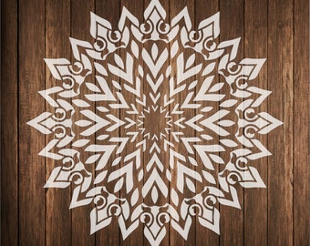 May include: White mandala design on a brown wood background. The mandala has a circular shape with intricate patterns and details.