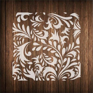 May include: White floral pattern stencil design on a brown wood background.