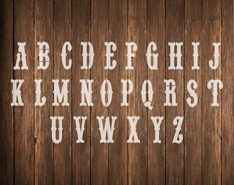 May include: White letters of the alphabet A through Z in a western style font on a brown wood background.