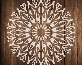 May include: White mandala design on a brown wood background. The mandala is a circular pattern with intricate details.