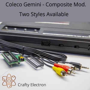 May include: A Coleco Gemini composite modification kit featuring a green circuit board with a black audio-video jack, a black plastic socket, and a long black cable ending in yellow, red, white, and black RCA and auxiliary connectors.