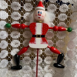 May include: A white ceramic mug with a black handle and the text "But First, Coffee" in a black, handwritten-style font. The mug is on a white surface.