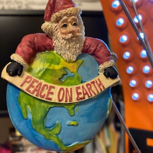 Santa holding the Earth Christmas ornament Peace on Earth