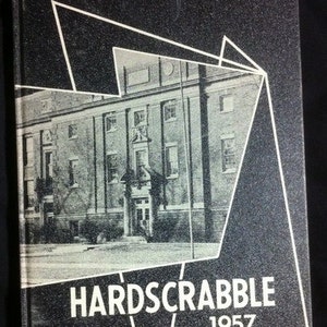 May include: A vintage yearbook cover with a black background and a grayscale image of a building. White geometric shapes frame the building. The title "HARDSCRABBLE 1957" is printed in white at the bottom.