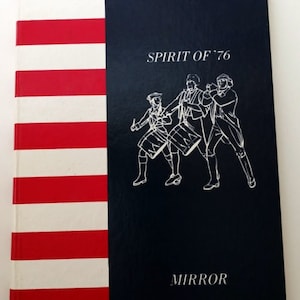 May include: A vintage hardcover book with a red, white, and blue striped cover. The front cover features a black and white illustration of three men in colonial attire playing drums. The title "SPIRIT OF '76" is printed in white on a black background. The word "MIRROR" is printed in white at the bottom of the cover.