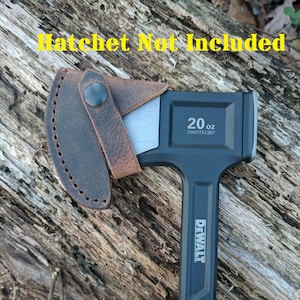 May include: A black and yellow DeWalt 20 oz. hatchet with a leather sheath. The hatchet has a black handle with a yellow grip and the text "DEWALT" printed on the handle. The sheath is brown leather with a strap.