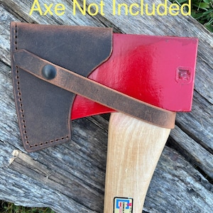 May include: Axe head cover made of brown leather, secured with a strap and a black button. The axe head is red, with a wooden handle. The text "Axe Not Included" is visible in the image.