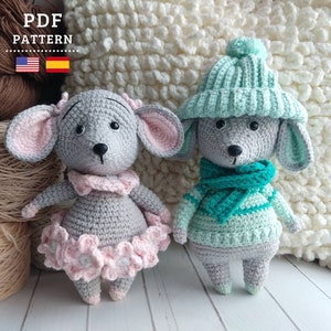 May include: Two crocheted mouse amigurumi toys. One is gray with a pink tutu and the other is light green with a green and white striped sweater and a green hat.
