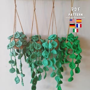 May include: Four crocheted hanging plant baskets with tan pots and long, trailing green vines featuring round leaves. The text PDF PATTERN is visible, along with small flag icons for the United States, Spain, Germany, France, and Italy.