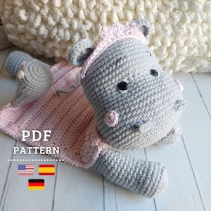 May include: A crochet pattern for a gray and pink hippopotamus wearing a pink crown. The pattern is available in English and German. PDF PATTERN.