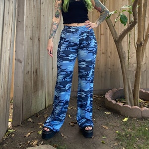 Y2K blue camouflage wide leg pants. Stretchy polyester material with elastic waist. Labeled juniors 2XL, fit an adult medium.