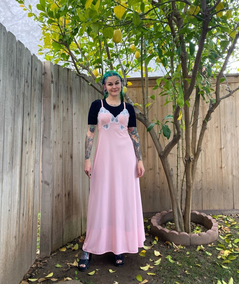 1970’s vintage nightgown. Pink nylon with white lace. Semi sheer all over. Sits at the ankles. Labeled medium.