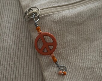 Orange peace sign zipper pull