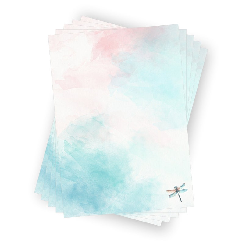 Peut inclure: Une pile de papier &agrave; lettres vierge avec un fond aquarelle dans des tons de rose et de bleu. Une libellule est imprim&eacute;e dans le coin inf&eacute;rieur droit.