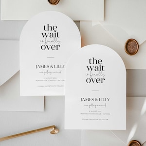 May include: Two white save the date cards with an arch shape at the top. The text on the cards reads "the wait is finally over" and "JAMES & LILLY are getting married" with the date and location of the wedding. The cards are on top of white envelopes with a gold wax seal.